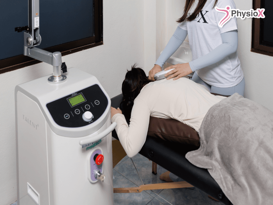 Physiotherapist using rehabilitation technology during a treatment session